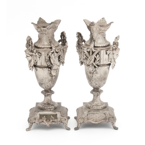 721 - A PAIR OF METAL SILVER-PAINTED URNS