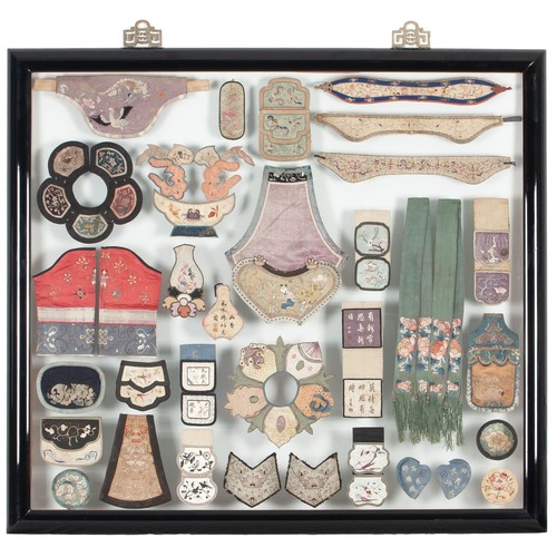 93 - A SET OF FRAMED MISCELLANEOUS HAND EMBROIDERED CHINESE SILK COLLARS, SILKS, SILK BINDINGS, MUFFS, AN... 