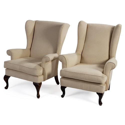 244 - A PAIR OF UPHOLSTERED WINGBACK ARMCHAIRS