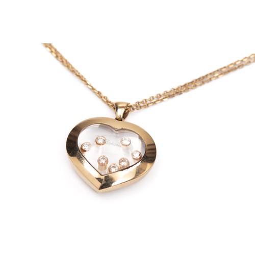 684 - A CHOPARD GOLD AND DIAMOND 'HAPPY DIAMONDS' HEART PENDANT