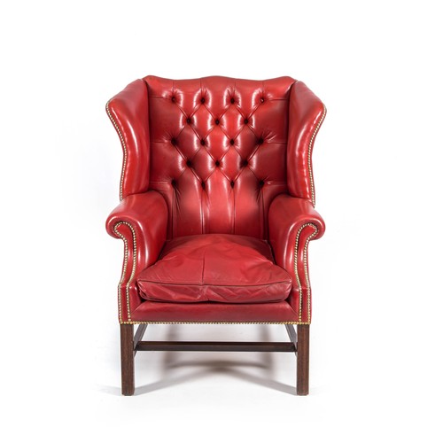 48 - A LEATHER UPHOLSTERED WING BACK ARMCHAIR