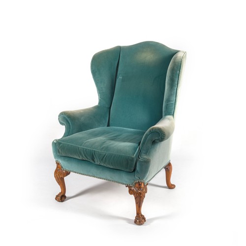 57 - AN UPHOLSTERED WINGBACK ARMCHAIR