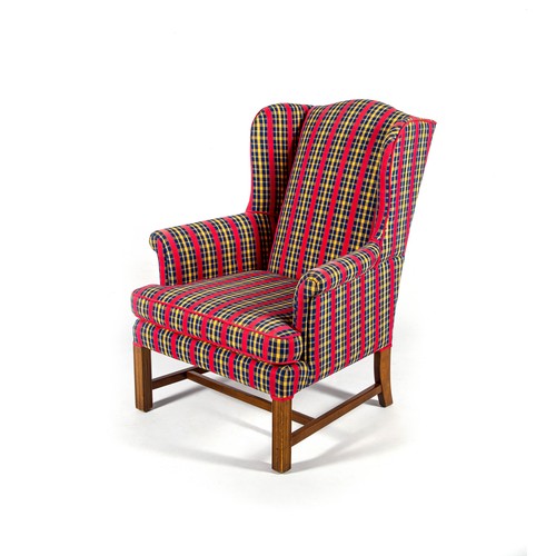 188 - AN UPHOLSTERED WINGBACK ARMCHAIR