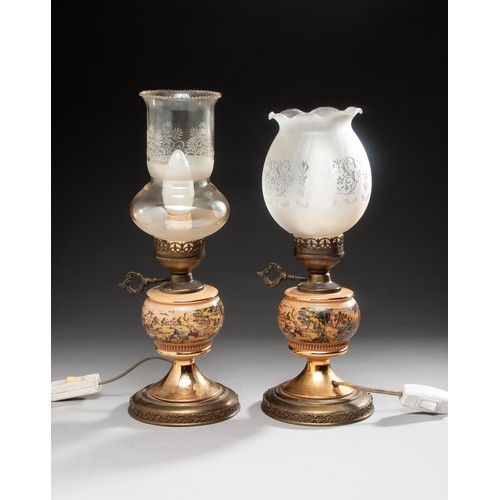 243 - A PAIR OF BRASS AND CERAMIC OIL LAMP BASES, WITH DIFFERENT GLASS SHADES, ELECTRIFIED