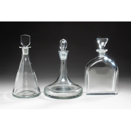 483 - A GROUP OF THREE GLASS DECANTERS AND STOPPERS