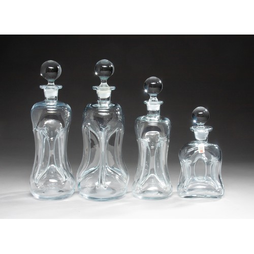 235 - A GROUP OF FOUR GLUG GLUG DECANTERS AND STOPPERS