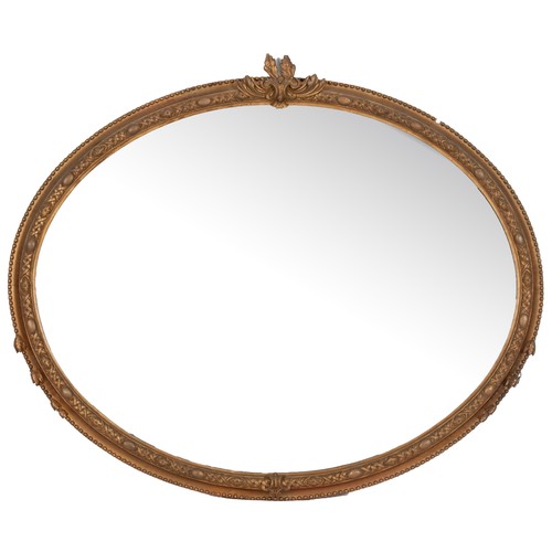 509 - A LARGE OVAL GILT-WOOD WALL MIRROR