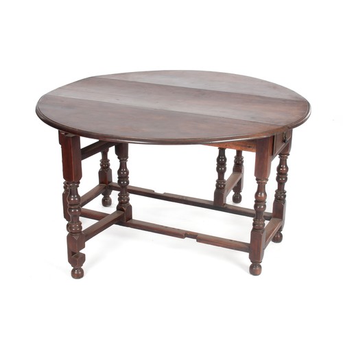 521 - AN OAK DROP-LEAF DINING TABLE