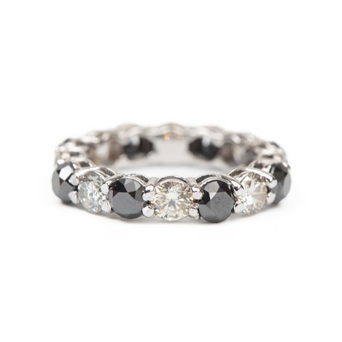 979 - A BLACK AND WHITE NATURAL FULL DIAMOND ETERNITY RING, 5.05 CARATS