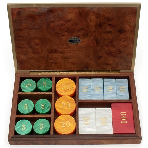 133 - A WALNUT AND BRASS CASED SET OF CASINO CHIPS