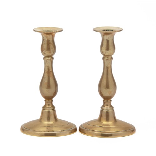 103 - A PAIR OF BRASS CANDLESTICKS