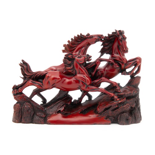 397 - A CHINESE RED RESIN SCULPTURE OF WILD GALLOPING HORSES