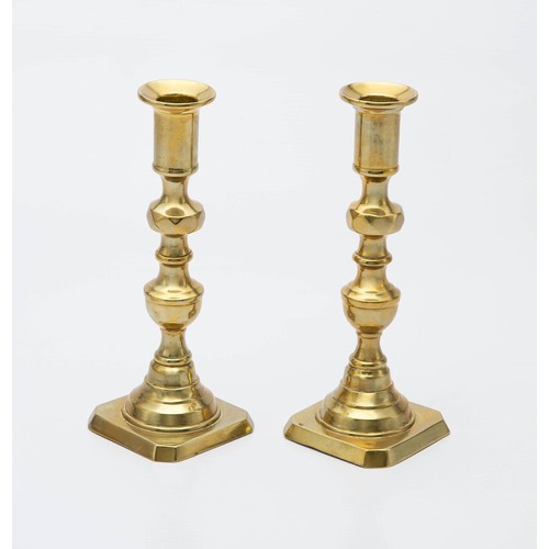 104 - A PAIR OF BRASS CANDLESTICKS