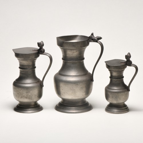 1337 - THREE GRADUATED PEWTER PITCHERS