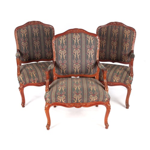 A SET OF THREE FRUITWOOD UPHOLSTERED ARMCHAIRS