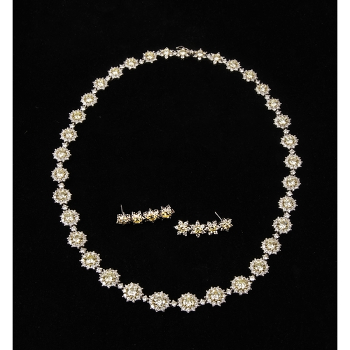 26 - A SUITE OF DIAMOND HALO JEWELLERY, 37.25 CARATS, CIRCA 1972