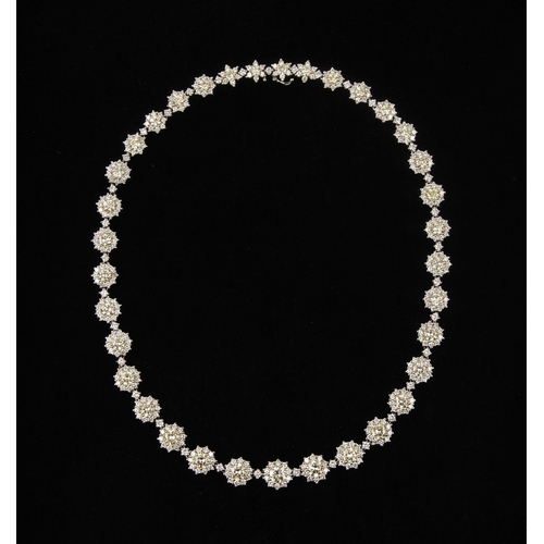 26 - A SUITE OF DIAMOND HALO JEWELLERY, 37.25 CARATS, CIRCA 1972