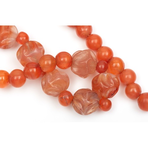 141 - A CHINESE HAND CARVED CARNELIAN AGATE NECKLACE