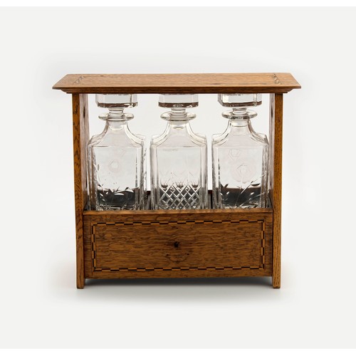 648 - A WOODEN TANTALUS AND THREE CRYSTAL DECANTERS