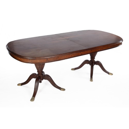 395 - AN OAK TWIN PEDESTAL EXTENDING DINING TABLE