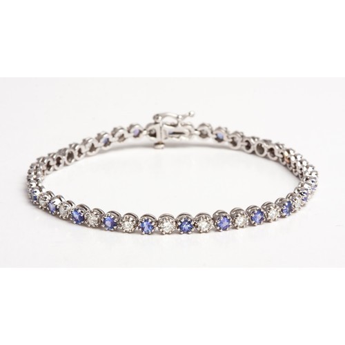 625 - A NATURAL DIAMOND AND TANZANITE TENNIS BRACELET