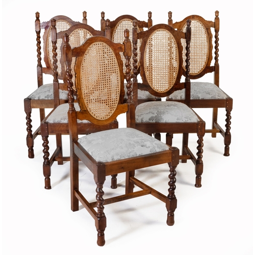 566 - A SET OF SIX OAK CANE AND UPHOLSTERED DINING CHAIRS