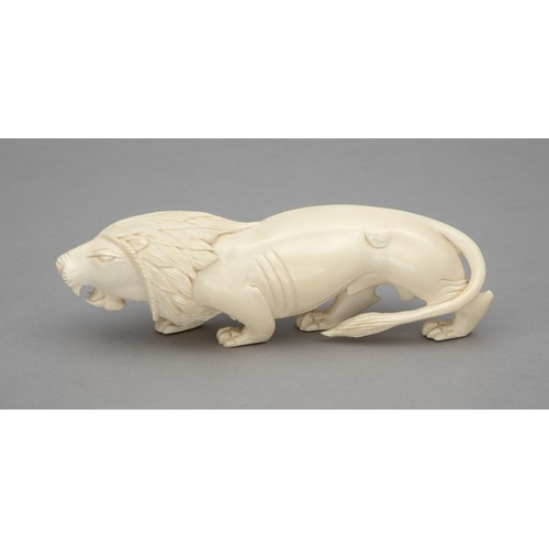 45 - A CARVED TUSK LION FIGURINE