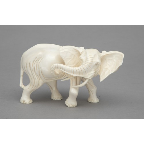 46 - A CARVED TUSK ELEPHANT FIGURINE, SIGNED PRARIMANZIRA, 1987