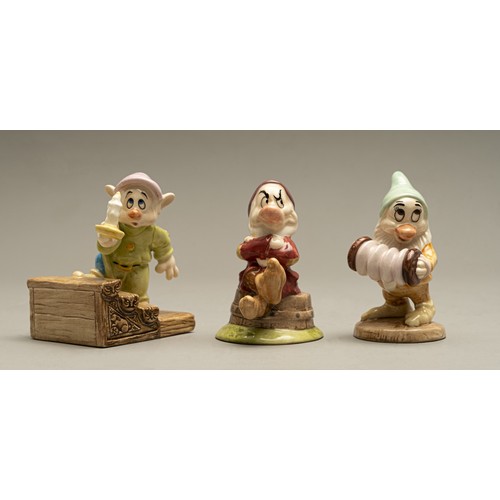 220 - THREE ROYAL DOULTON FIGURINES FROM THE 'SNOW WHITE AND THE SEVEN DWARFS' COLLECTION