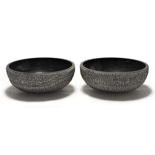 216 - A PAIR OF BLACK MARBLE AND CONCRETE BASINS