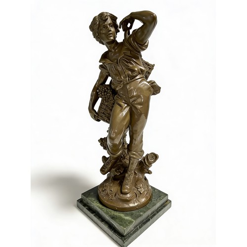 202 - A METAL CLAD FIGURE OF A GRAPE PICKER