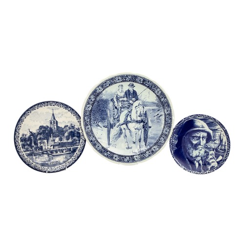498 - A LARGE BLUE AND WHITE DELFT BLAUW CHARGER AND TWO SMALLER DELFT PLATES