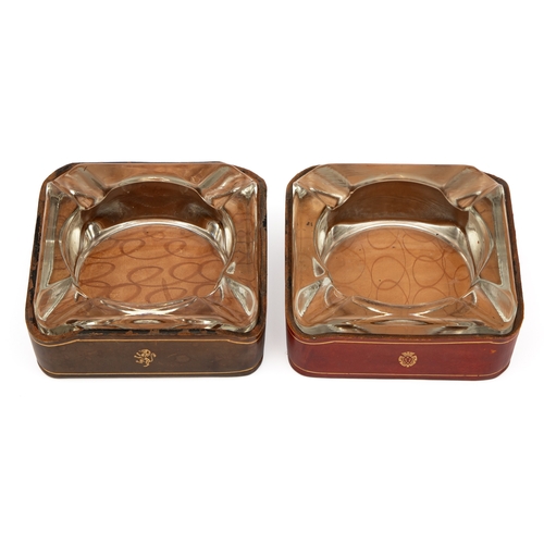 28 - A PAIR OF MID-CENTURY ITALIAN GILT-TOOLED CALFSKIN LEATHER AND HEAVY GLASS ASHTRAYS, MID-20TH CENTUR... 