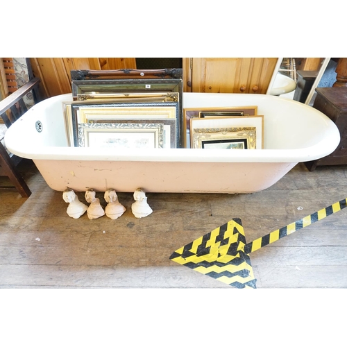 19 - A large cast iron bath with decorative feet