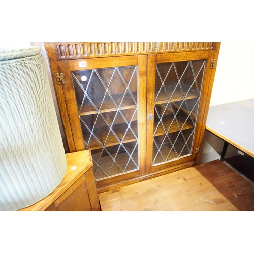 197 - An oak and leaded glazed display cabinet