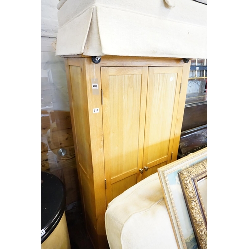 210 - An oak cupboard with shelved interior