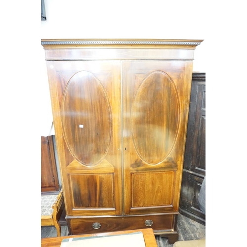 305 - A good quality Edwardian mahogany wardrobe with oval and square panelling to drawers above a drawer,... 
