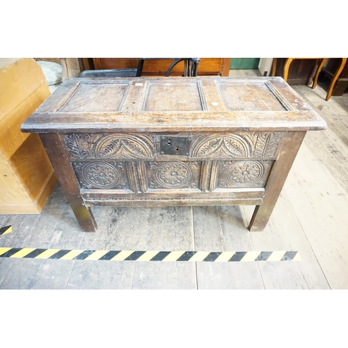 319 - A panelled oak trunk with carved detail
