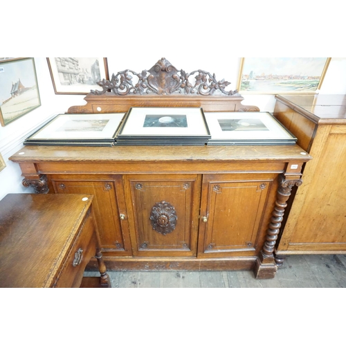 352 - A good quality oak sideboard with carved detail to the pediment, panelled doors, barley twist balust... 
