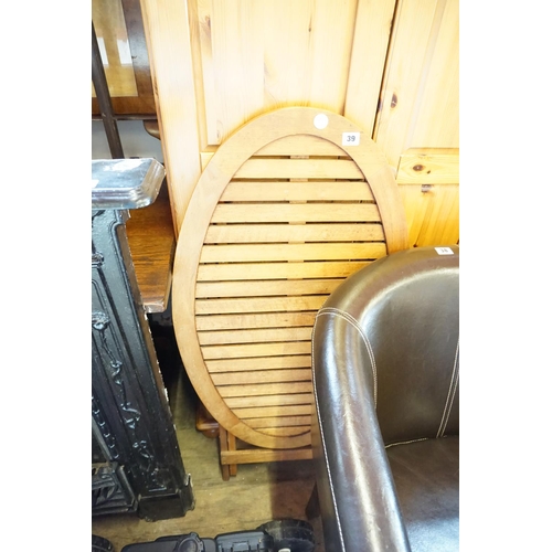 39 - A slatted oval topped folding table