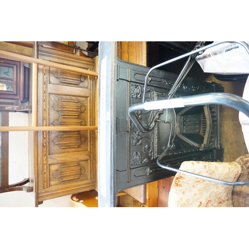 44 - An Arts & Crafts period decorative cast iron fire surround