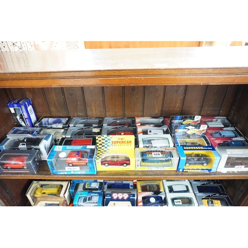528 - A collection of boxed model vehicles (top shelf)