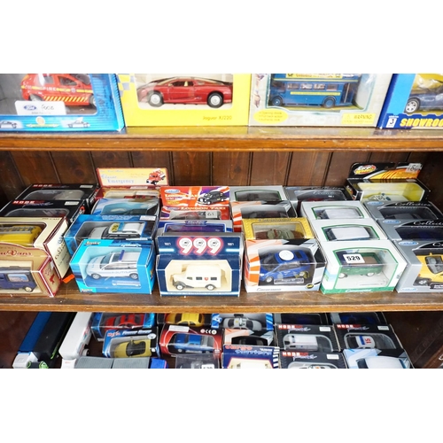 529 - A collection of boxed model vehicles (middle shelf)