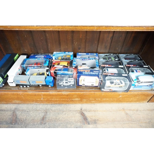530 - A collection of boxed model vehicles (bottom shelf)