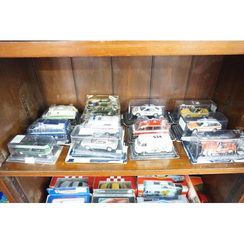 534 - A collection of boxed model vehicles (top shelf)