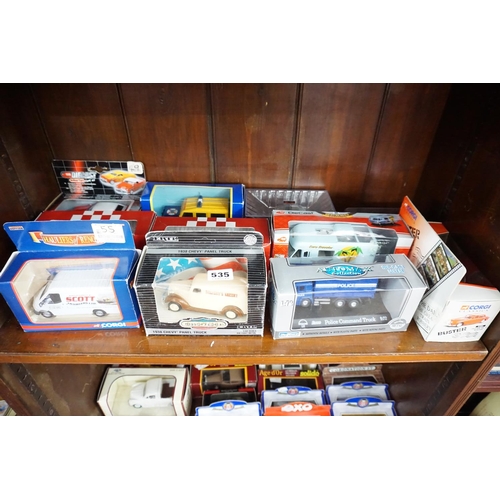 535 - A collection of boxed model vehicles - (middle shelf)