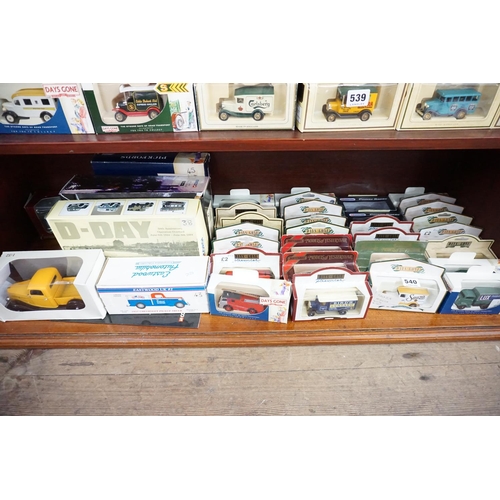 540 - A collection of boxed model vehicles - (bottom shelf)