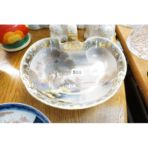 556 - A decorative bowl with handle