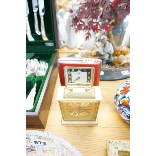 573 - A Swiza brass mantle clock and an alarm clock