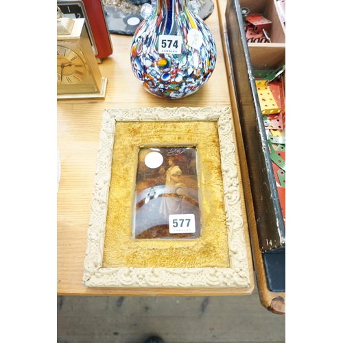 577 - A decoratively framed small picture